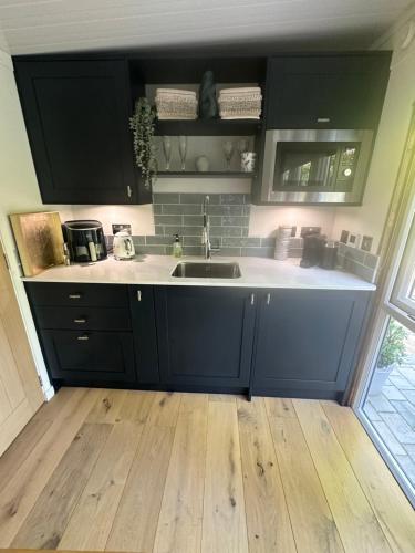 a kitchen with a sink and a counter top at Apple-tree lodge in Taunton