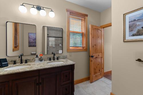 a bathroom with two sinks and a mirror at Luxury Chalet, Firepit, Sauna, Pet Friendly, 5 mins to Windham Mtn resort in Windham