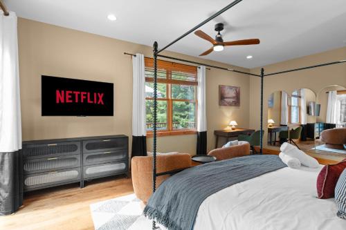 a bedroom with a bed with a netflix sign on the wall at Luxury Chalet, Firepit, Sauna, Pet Friendly, 5 mins to Windham Mtn resort in Windham