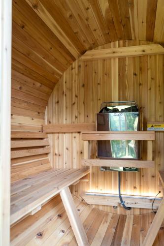 a wooden sauna with a bench in a room at Luxury Chalet, Firepit, Sauna, Pet Friendly, 5 mins to Windham Mtn resort in Windham