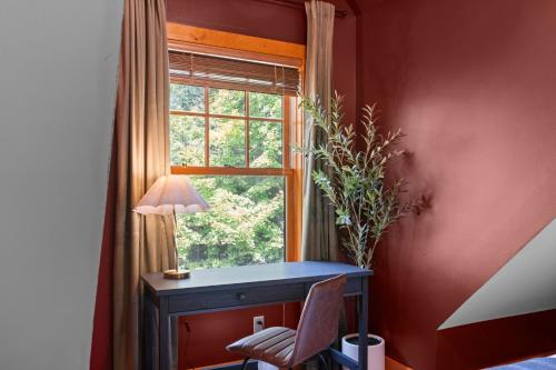 a desk with a chair in front of a window at Luxury Chalet, Firepit, Sauna, Pet Friendly, 5 mins to Windham Mtn resort in Windham