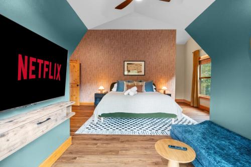 a bedroom with a bed and a flat screen tv at Luxury Chalet, Firepit, Sauna, Pet Friendly, 5 mins to Windham Mtn resort in Windham