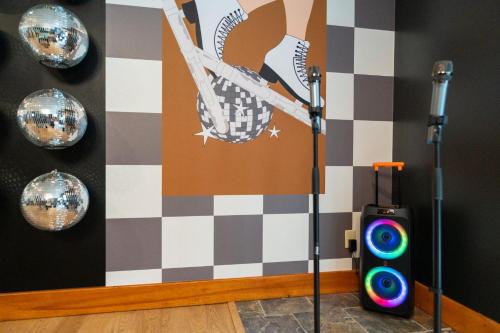 a room with a speaker and a wall with disco balls at Luxury Chalet, Firepit, Sauna, Pet Friendly, 5 mins to Windham Mtn resort in Windham