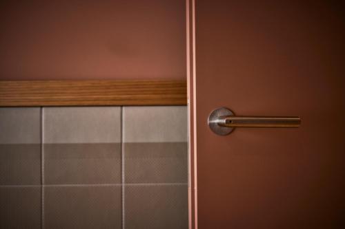 a close up of a door with a metal handle at Cà Nani Small Boutique Hotel in Casima