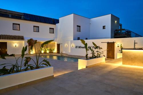 a villa with a swimming pool at night at El Mirador del Valle in San Jose del Valle