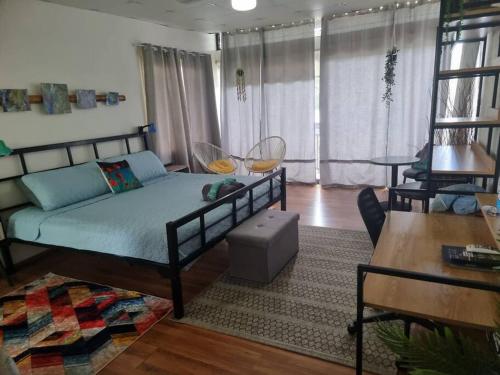 a bedroom with a bed and a living room at Cool Loft with King Bed 10 mins David 20 mins to Boquete in Dolega