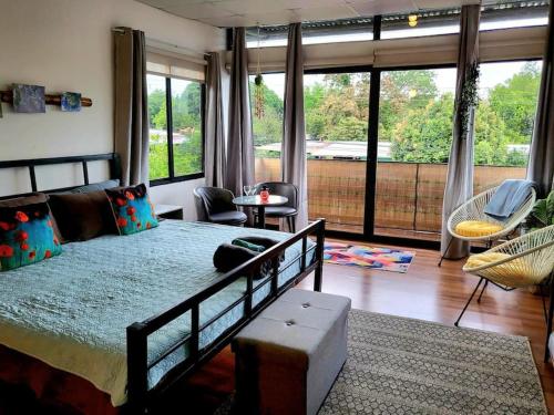 a bedroom with a large bed and a large window at Cool Loft with King Bed 10 mins David 20 mins to Boquete in Dolega