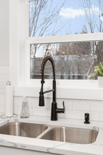 a kitchen sink with a faucet and a window at Spacious Family Villa only 13 mi from Silverwood in Hayden