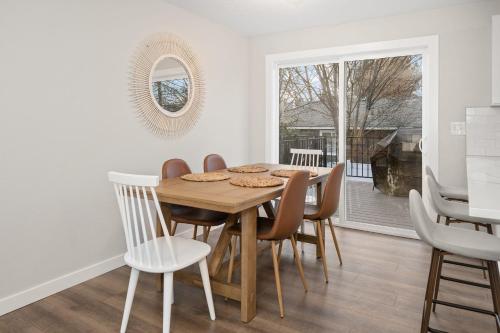 a dining room with a wooden table and chairs at Spacious Family Villa only 13 mi from Silverwood in Hayden