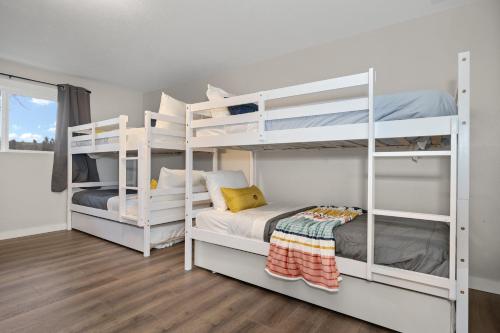 two white bunk beds in a room at Spacious Family Villa only 13 mi from Silverwood in Hayden