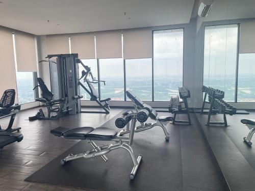 a gym with cardio equipment in a building with windows at H Residence Hill10 I-City in Shah Alam