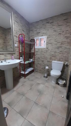 a bathroom with a sink and a toilet and a mirror at Almaden 7A in Castilblanco de los Arroyos
