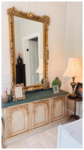 a mirror on top of a dresser in a room at Cozy Place on Main Floor in Toronto