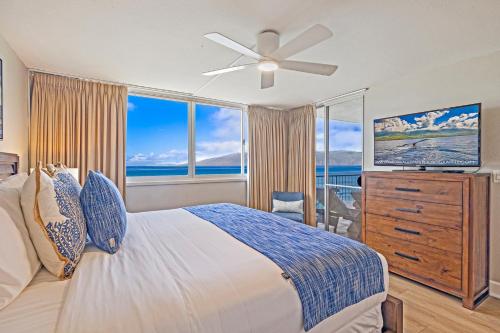 a bedroom with a bed and a large window at Royal Kahana 1010 in Kahana