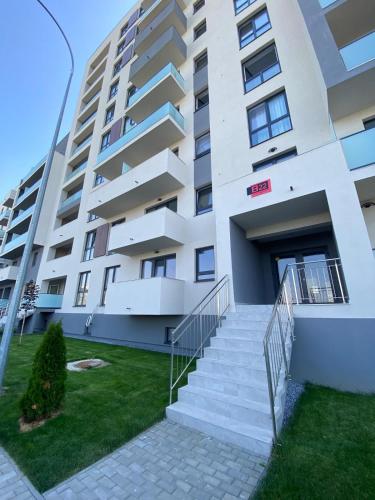 a building with stairs in front of it at Luxury & Cozy Apartment - Maurer Residence Tg-Mureș in Târgu-Mureş