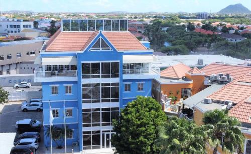 an overhead view of a blue building in a city at Bocobay Penthouse 4BR 4BA with Rooftop Pool in Oranjestad