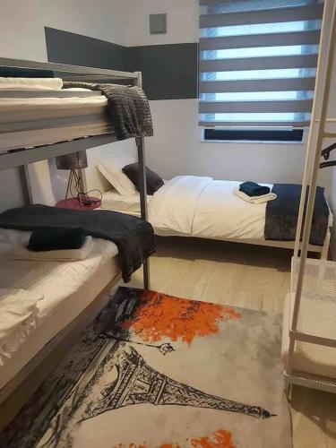 a room with two bunk beds and a rug at Friendly house in Bastogne 130 m² with private garden for 5 people in Bastogne