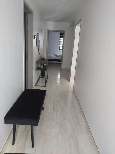 a living room with a black bench and a mirror at Friendly house in Bastogne 130 m² with private garden for 5 people in Bastogne