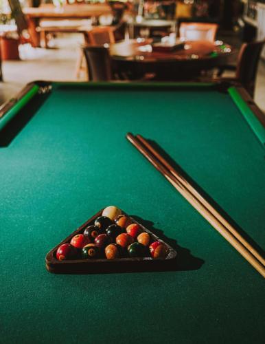 a tray of billiard balls on top of a pool table at Casa Conicarit in Puerto Escondido