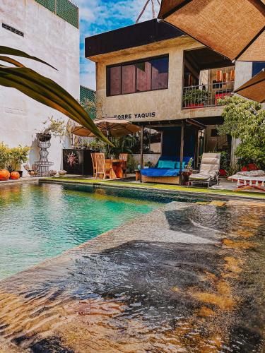 a swimming pool in front of a building at Casa Conicarit in Puerto Escondido