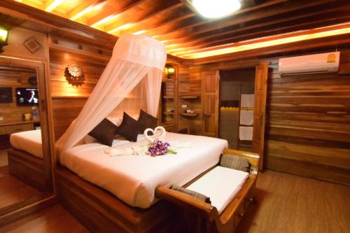 a bedroom with a bed in the middle of a boat at Villa Habeebee in Ao Nang Beach