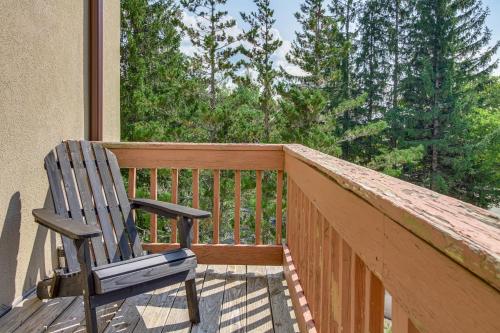 a rocking chair sitting on the deck of a house at Bearfoot Apres Mtn-View Condo Less Than 1 Mi to Mt Snow! in Podunk