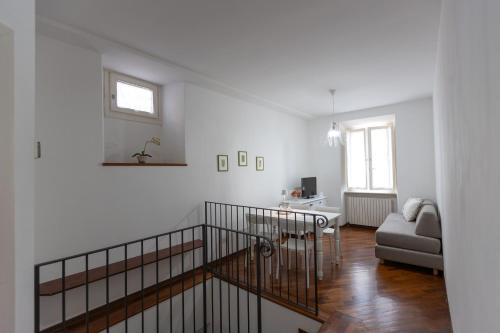 a white living room with a couch and a table at Palazzo Antico in Ascoli Piceno
