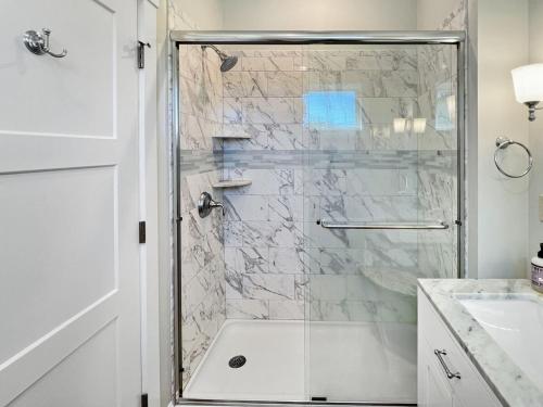 a bathroom with a shower with a glass door at Long Sands Your All-Season GetAway Brought to you by GetAway Vacations in York