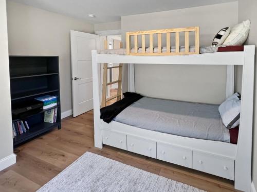 a small bedroom with a bunk bed and a television at Long Sands Your All-Season GetAway Brought to you by GetAway Vacations in York
