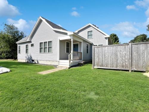 a white house with a fence in a yard at Long Sands Your All-Season GetAway Brought to you by GetAway Vacations in York