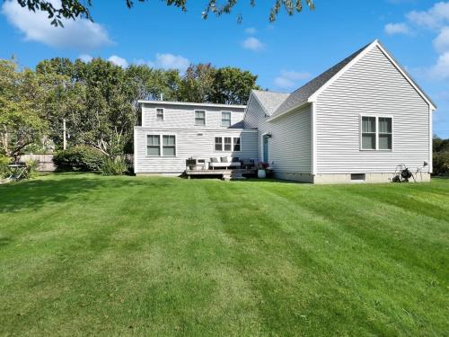 a white house with a large yard at Long Sands Your All-Season GetAway Brought to you by GetAway Vacations in York