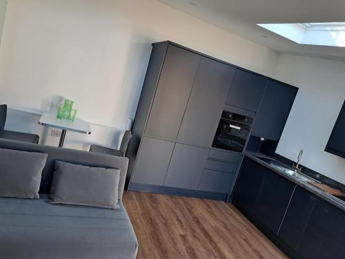 a living room with a couch and a kitchen at Cavehill Cottage in Belfast