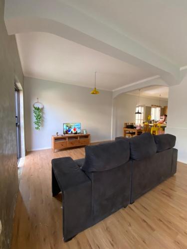 a living room with a couch and a table at Casa Aconchego - T2 in Espargos