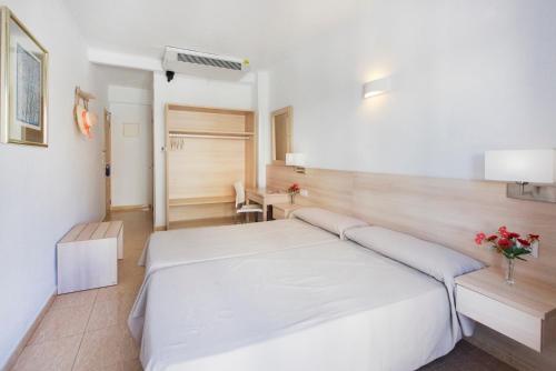 a bedroom with a white bed in a room at Hotel San Miguel in Altea