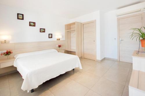 a white bedroom with a white bed in a room at Hotel San Miguel in Altea