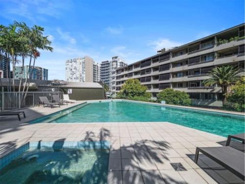 a swimming pool in the middle of a building at Luxury 4BR Cozy Home Pool, Gym, Sauna, wParking at CBD in Brisbane