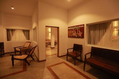 a living room with two chairs and a couch at Refresh Hotel Hikkaduwa in Hikkaduwa