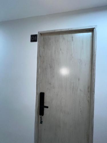 a door in a room with a sign on the wall at Laureles Inn in América