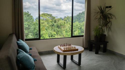 a living room with a table and a large window at Divan Eco Lodge in Fortuna