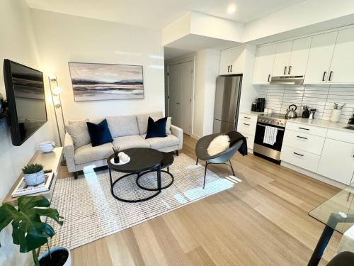 a living room with a couch and a table at Central Moodyville Retreat in North Vancouver