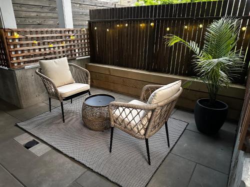 two chairs and a table on a patio at Central Moodyville Retreat in North Vancouver