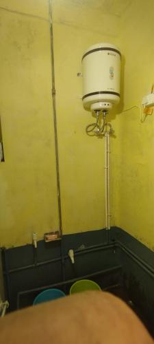 a bucket on the wall of a room with chairs at Viswanatham Guest House in Varanasi