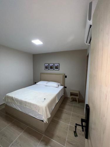 a bedroom with a large bed in a room at Laureles Inn in América