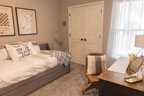 a bedroom with a bed and a desk and a desk at Brand New 2 Bedroom with Office in Loves Park