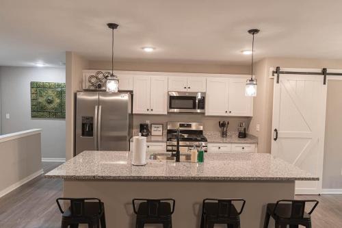 a kitchen with a counter and a refrigerator at Brand New 2 Bed with Office in Loves Park