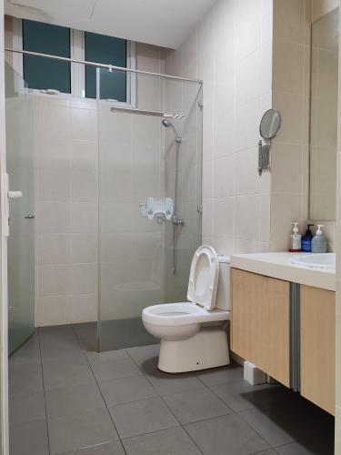 a bathroom with a toilet and a shower and a sink at Seaview Vacation Condo 3R3B 8Pax in Kampong Batu Maung