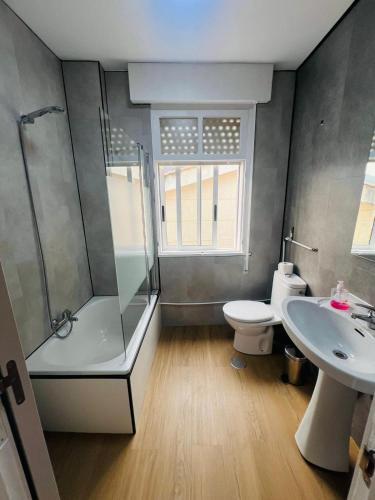 a bathroom with a shower and a toilet and a sink at A de Maritina - Tres Marias Apartaments in Redondela