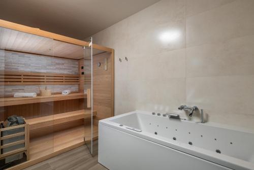 a bathroom with a bath tub and a shower at Villa MaEm in Juršići