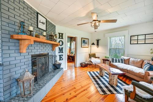 a living room with a blue brick fireplace at Country Escape Log Cabin Near Kentucky Lake! in Gilbertsville