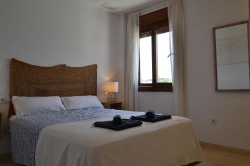 a bedroom with a bed with two towels on it at Penthouse City Center - Jerez in Jerez de la Frontera